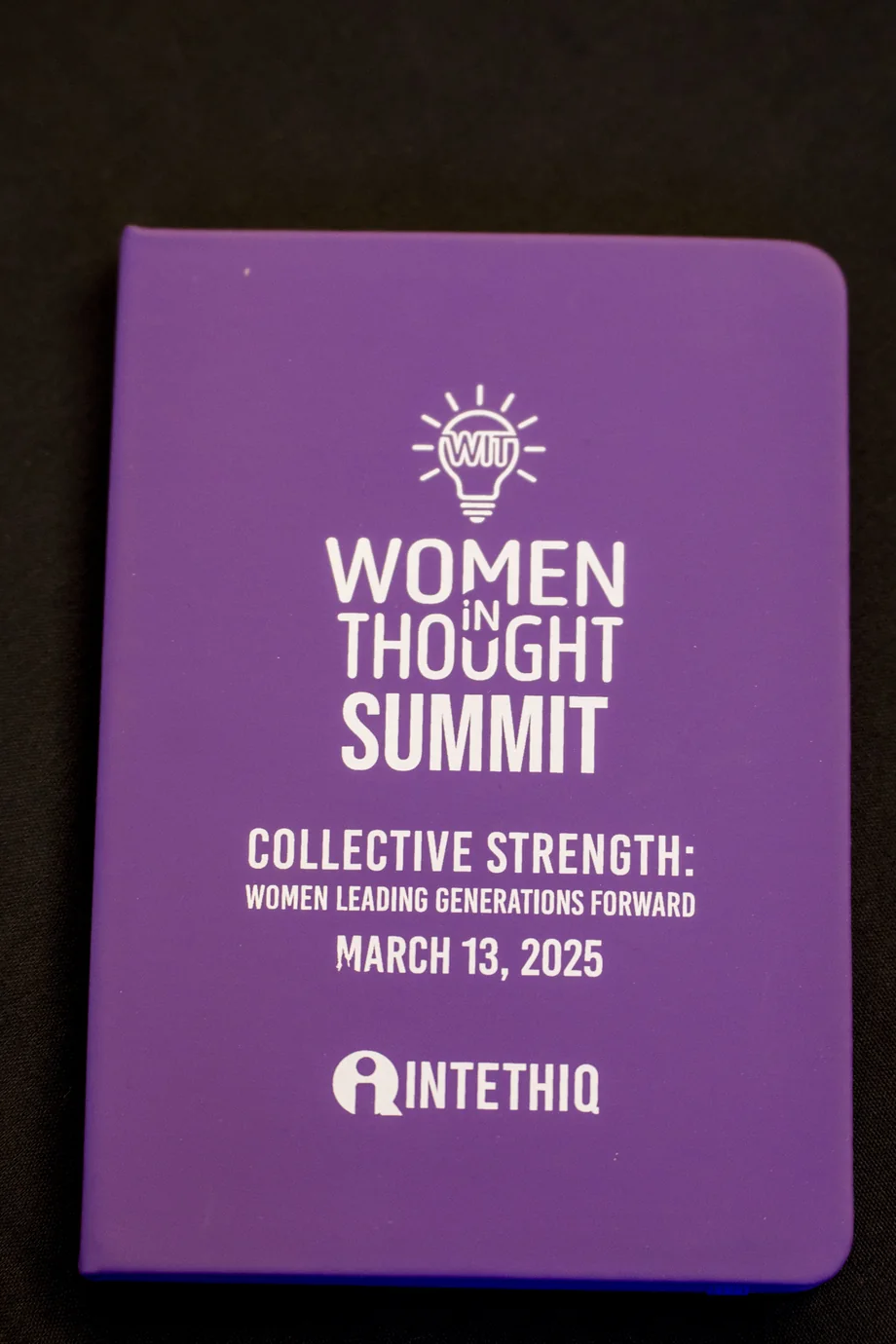 Finished Women in Thought Summit book giveaway physically present on an event table.